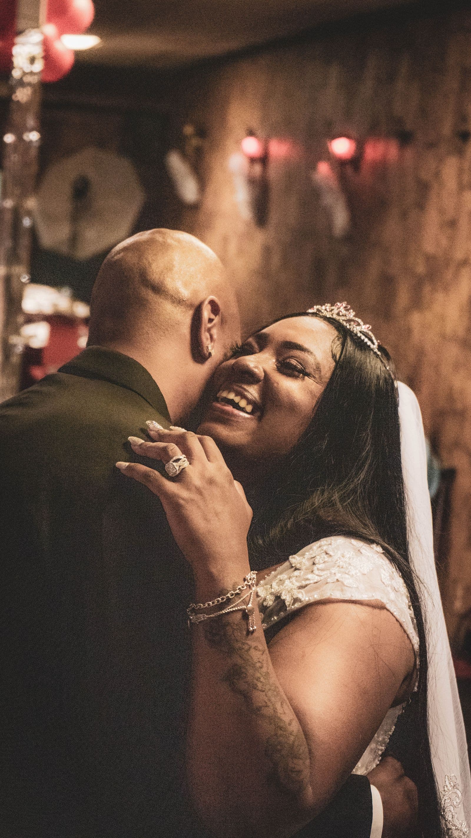 A bride and groom embracing warmly at their reception
