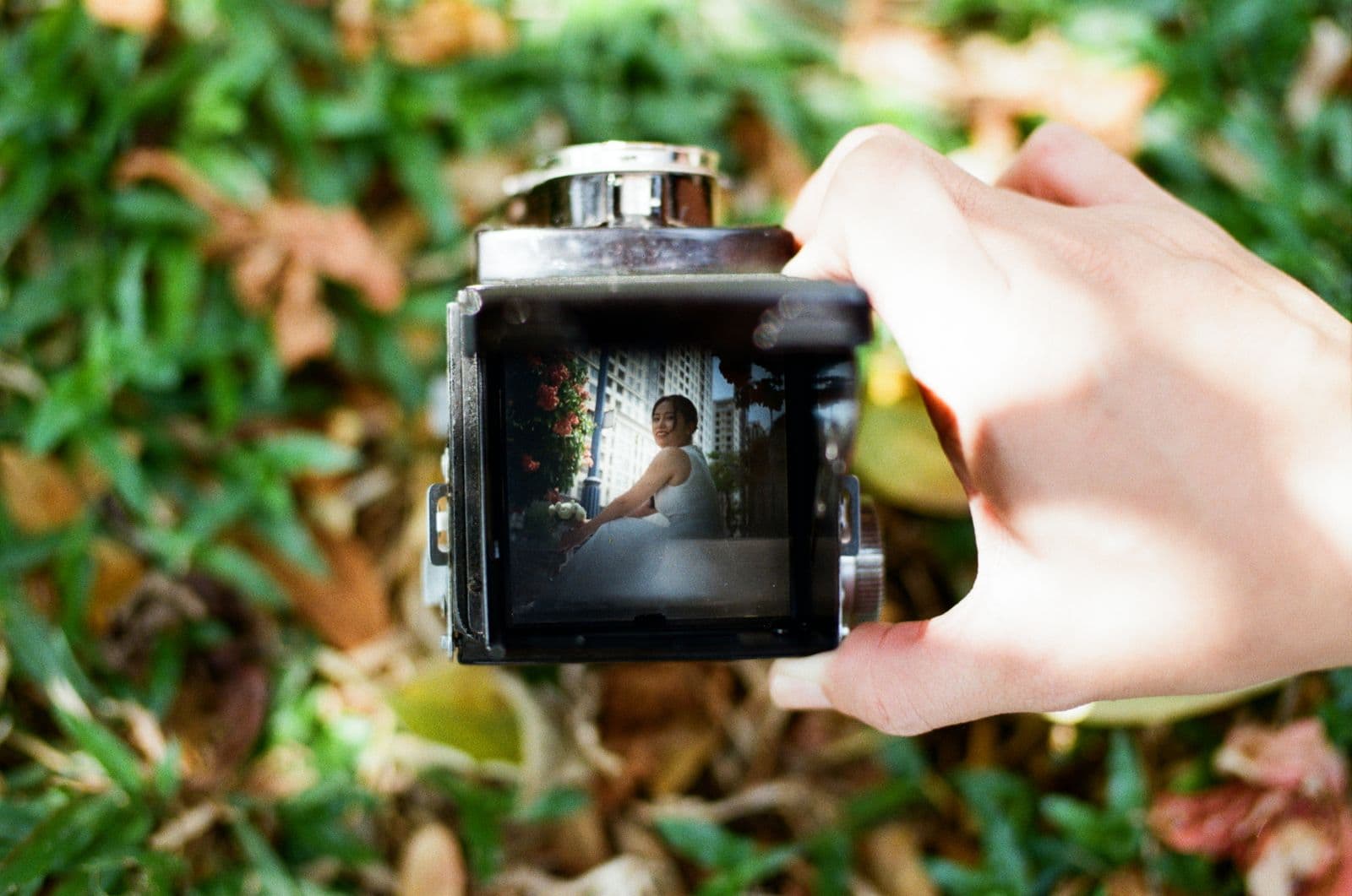 A bride framed in the viewfinder of a vintage film camera