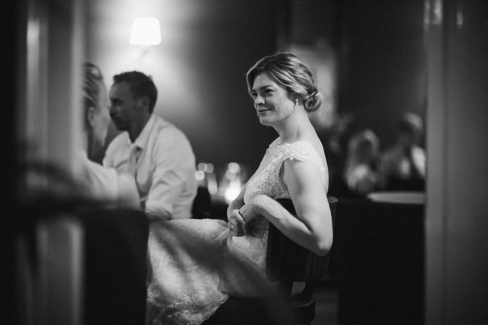 A bride at her wedding reception in black and white