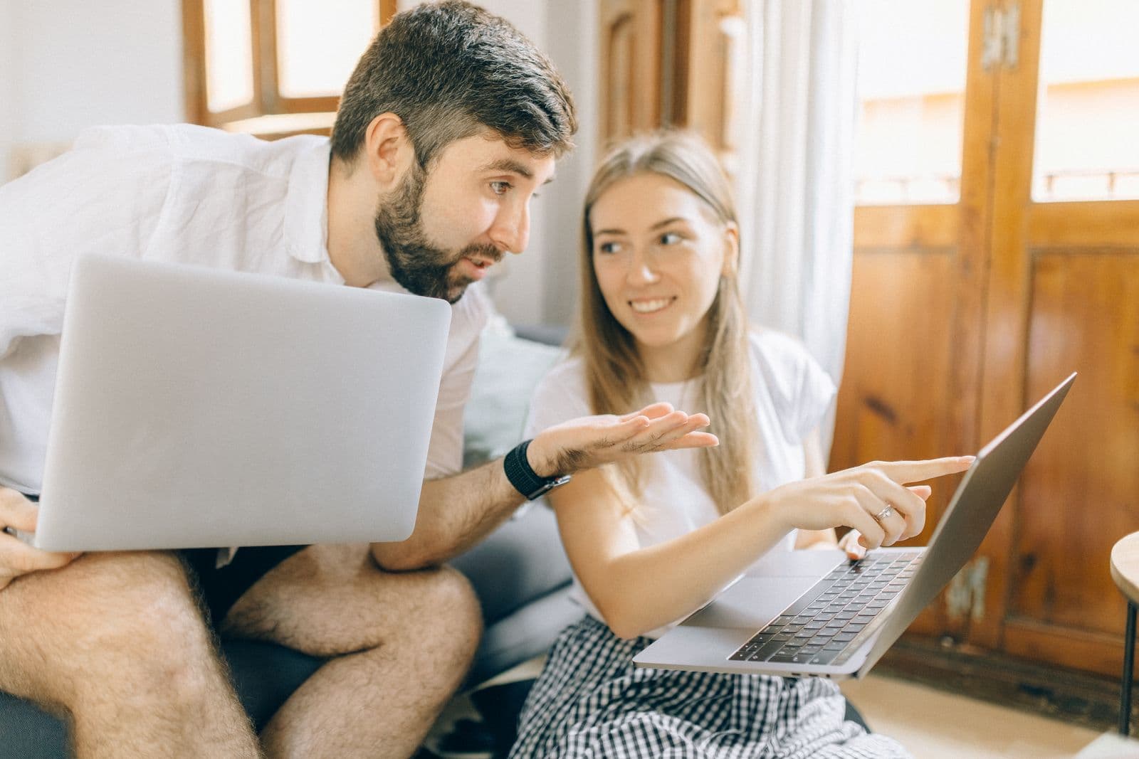 A couple sitting together comparing options on a laptop screen