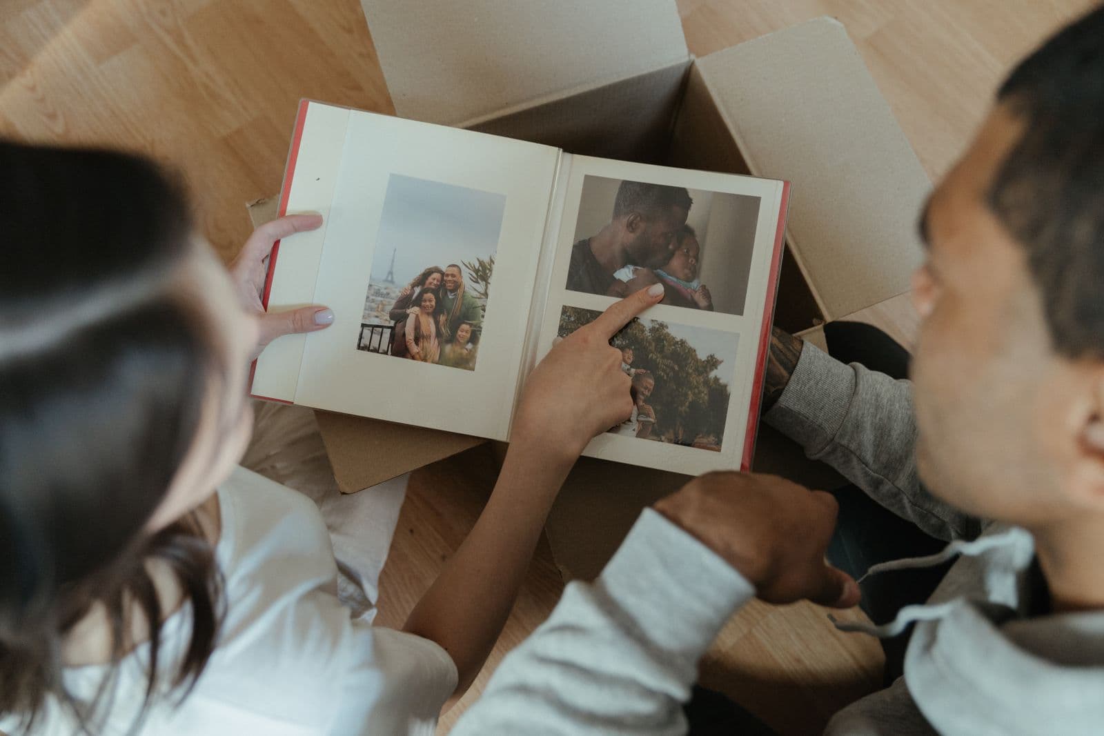 A couple looking through a printed photo album together