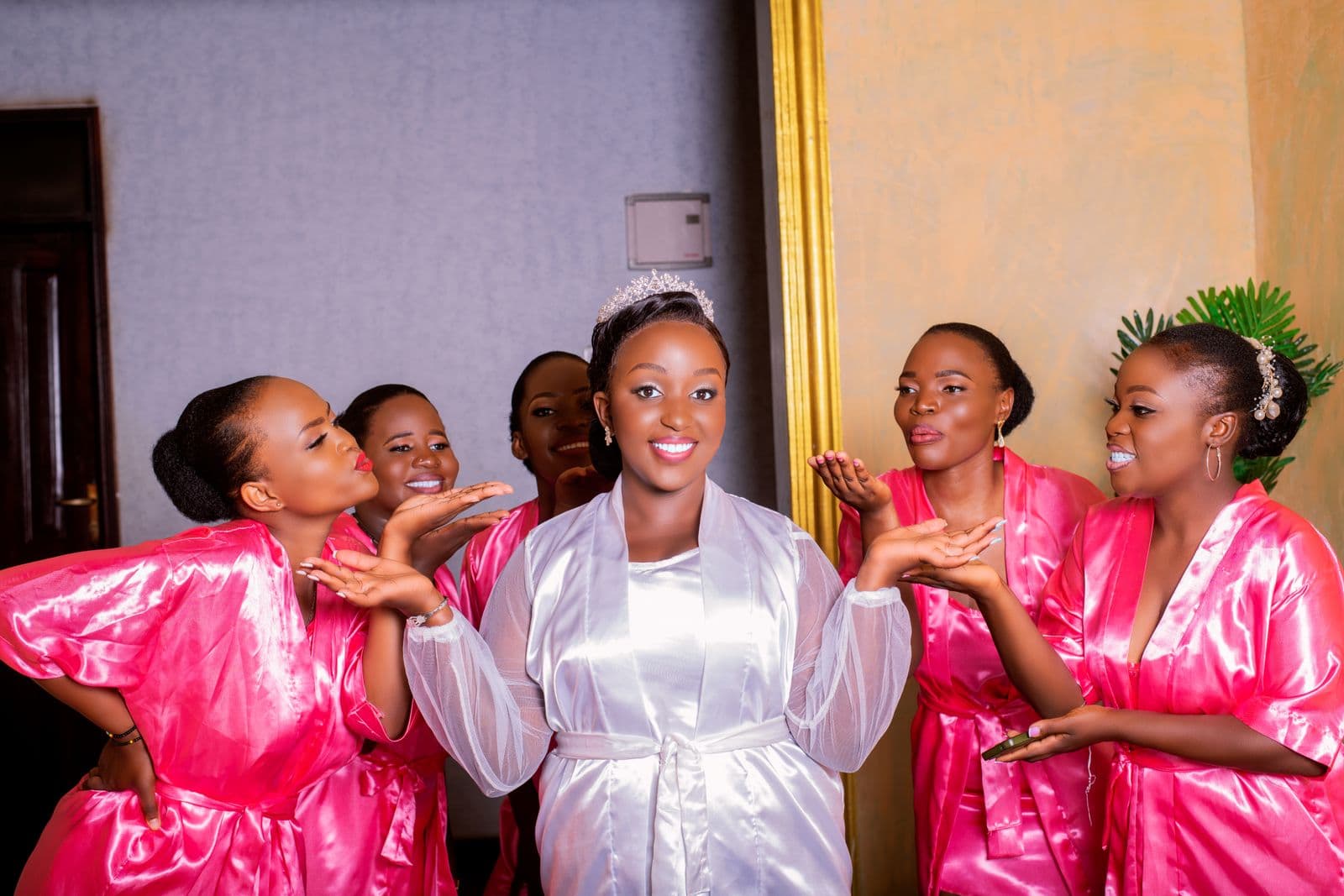 A bride and her bridesmaids in robes during a getting-ready moment before the wedding