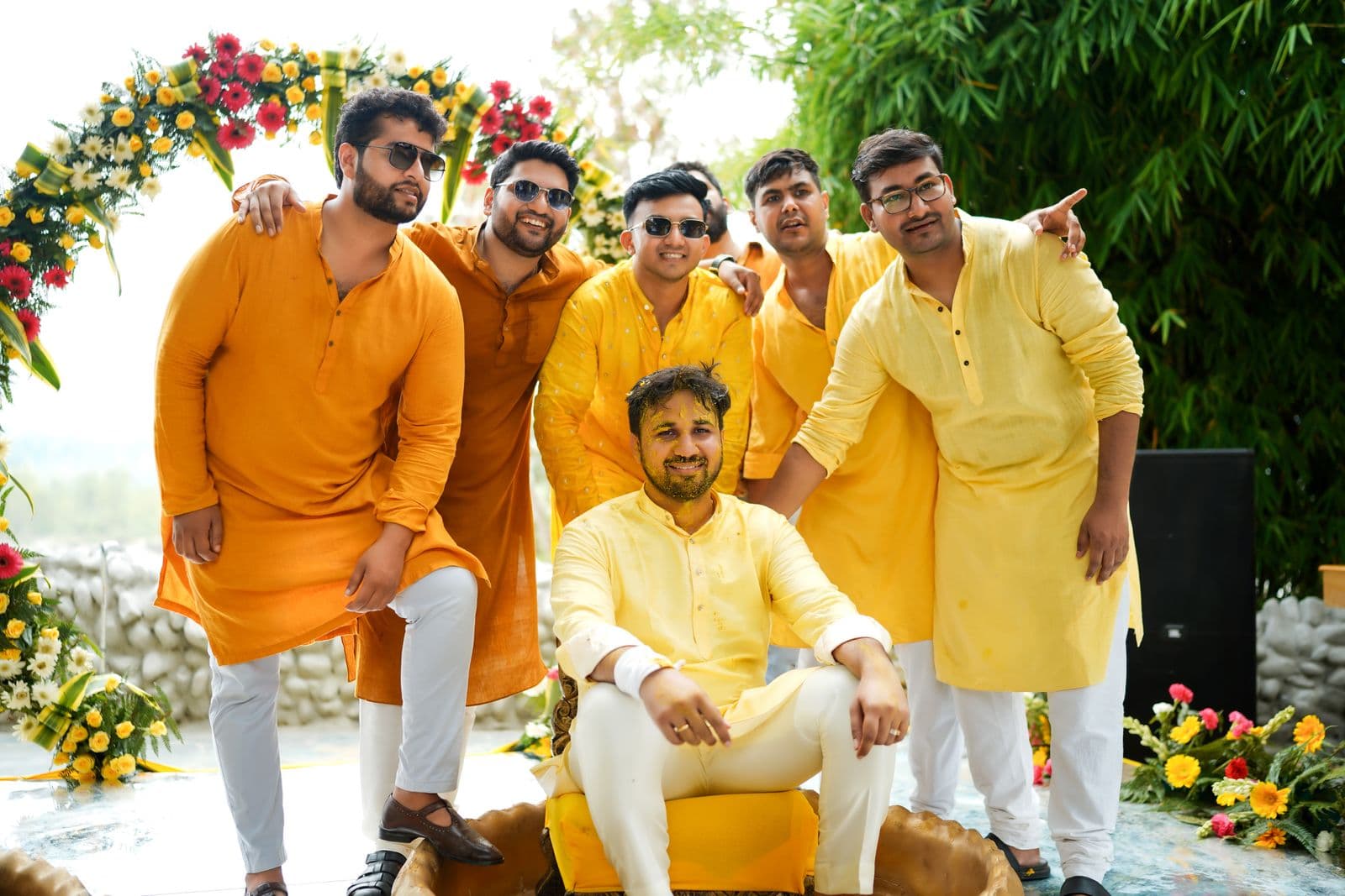 A groom and his friends in yellow at a pre-wedding celebration