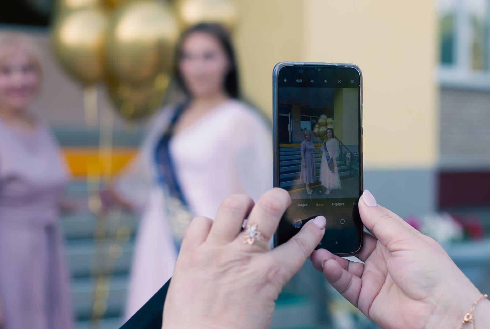 A guest using a phone to photograph friends at a celebration