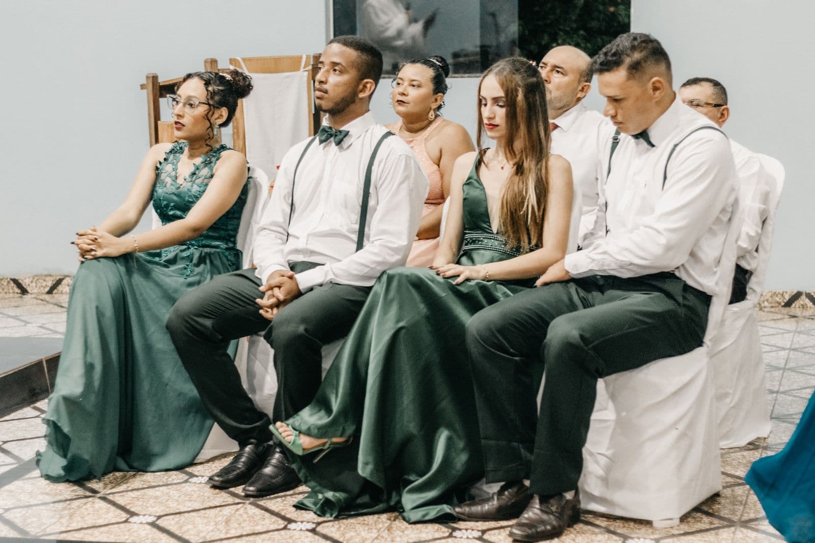 Wedding guests seated and watching the ceremony attentively, phones away