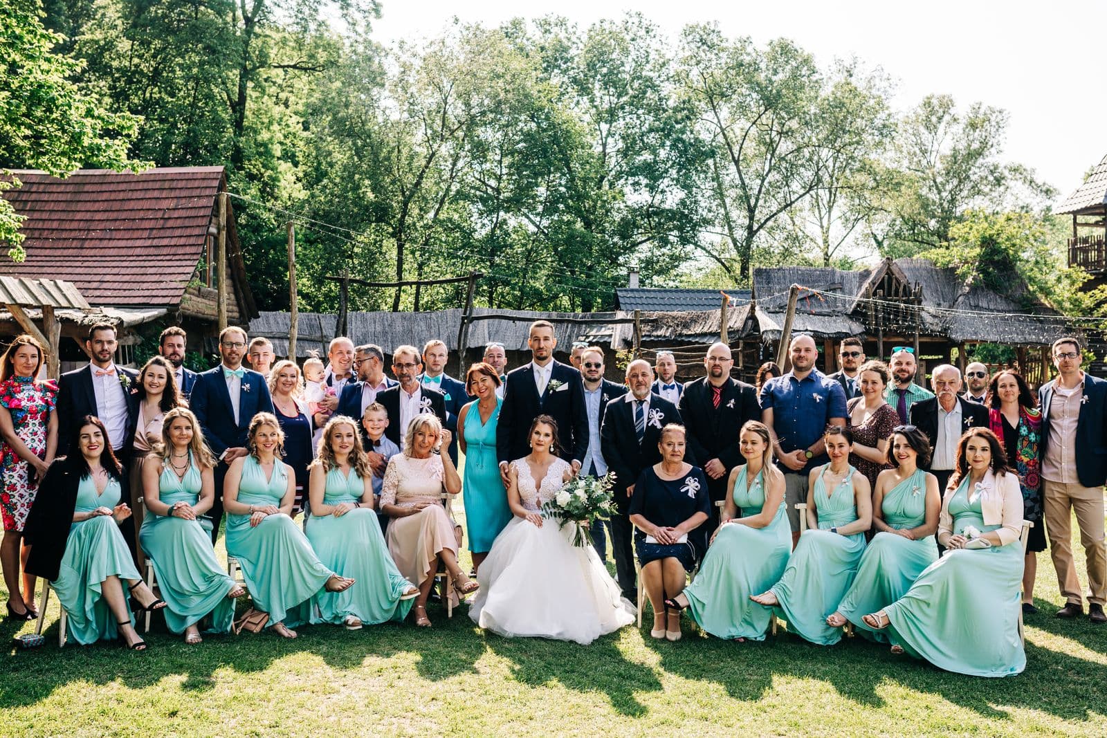 A large group photo of wedding guests with the couple