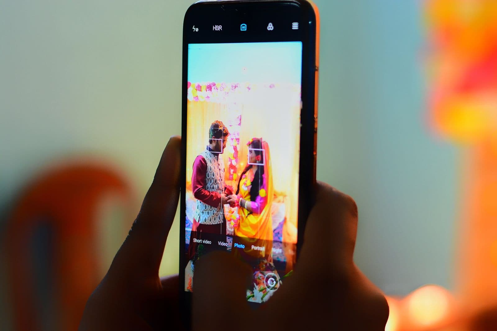 A guest capturing the couple on their phone during a wedding ceremony