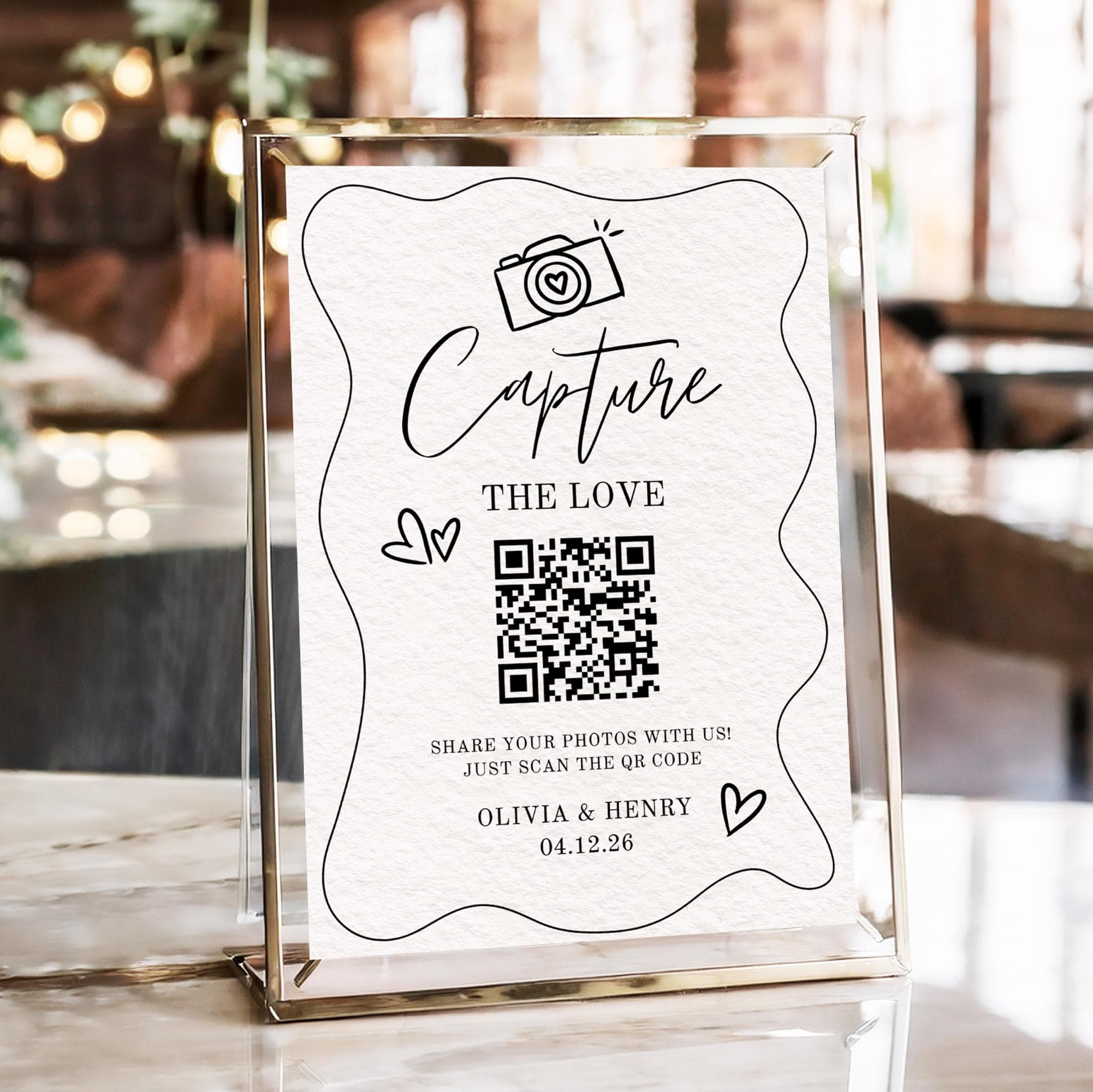 A wedding guest scanning a printed table QR code with their phone to upload photos