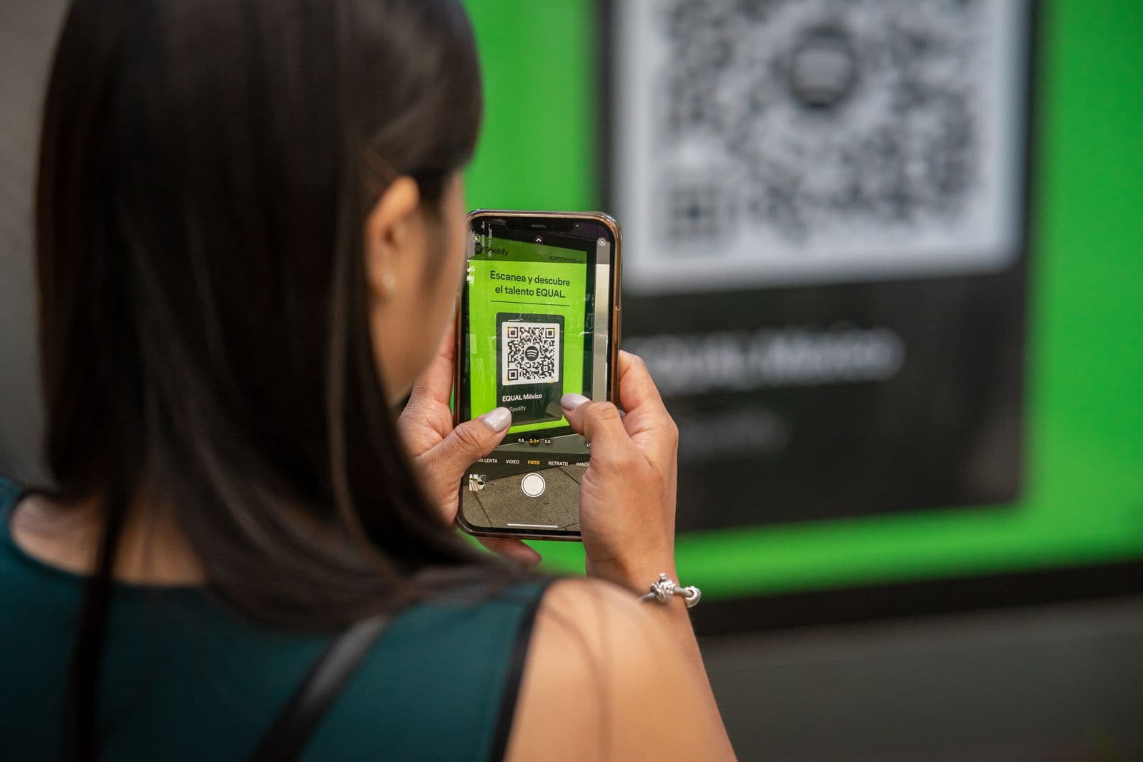 A person scanning a QR code with their phone camera