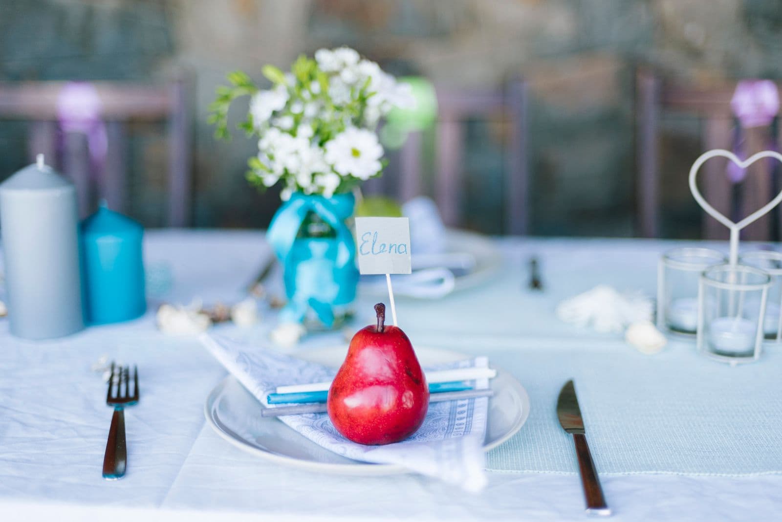 A wedding place setting with a handwritten name card, the natural spot for a photo-sharing QR code sign