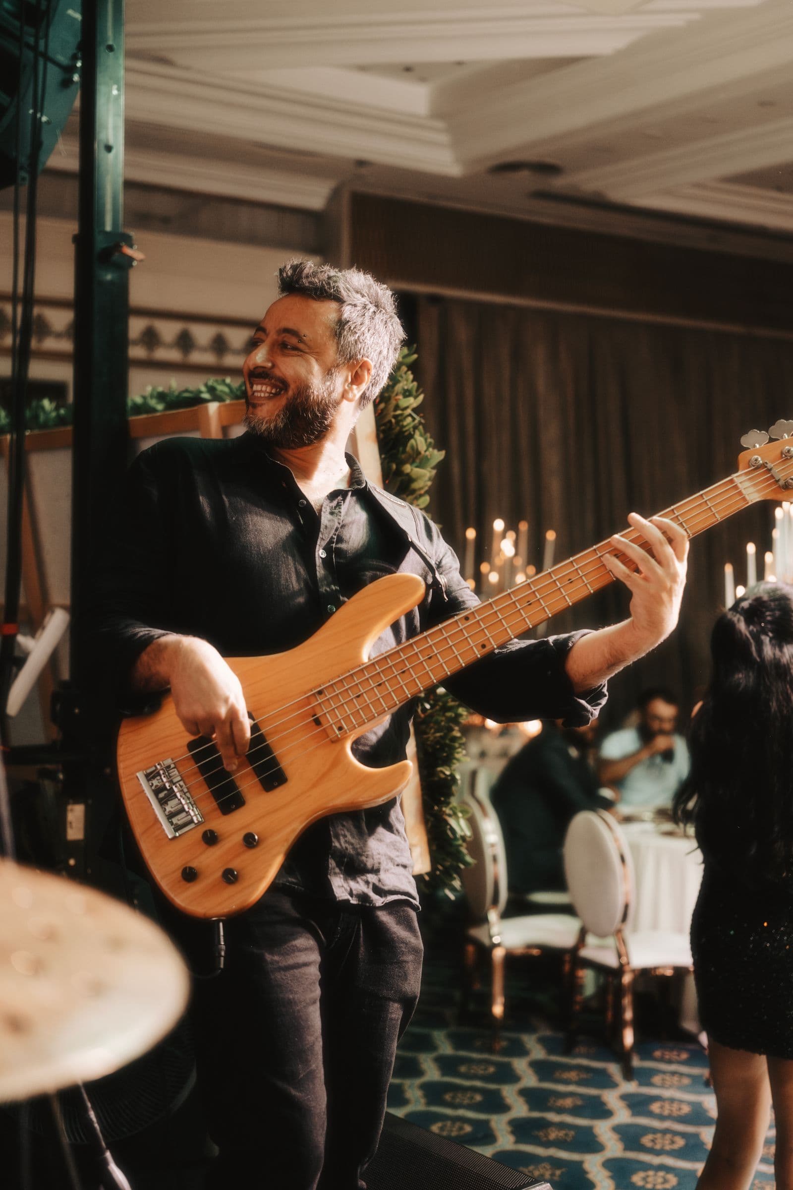 A musician playing bass guitar at a wedding reception