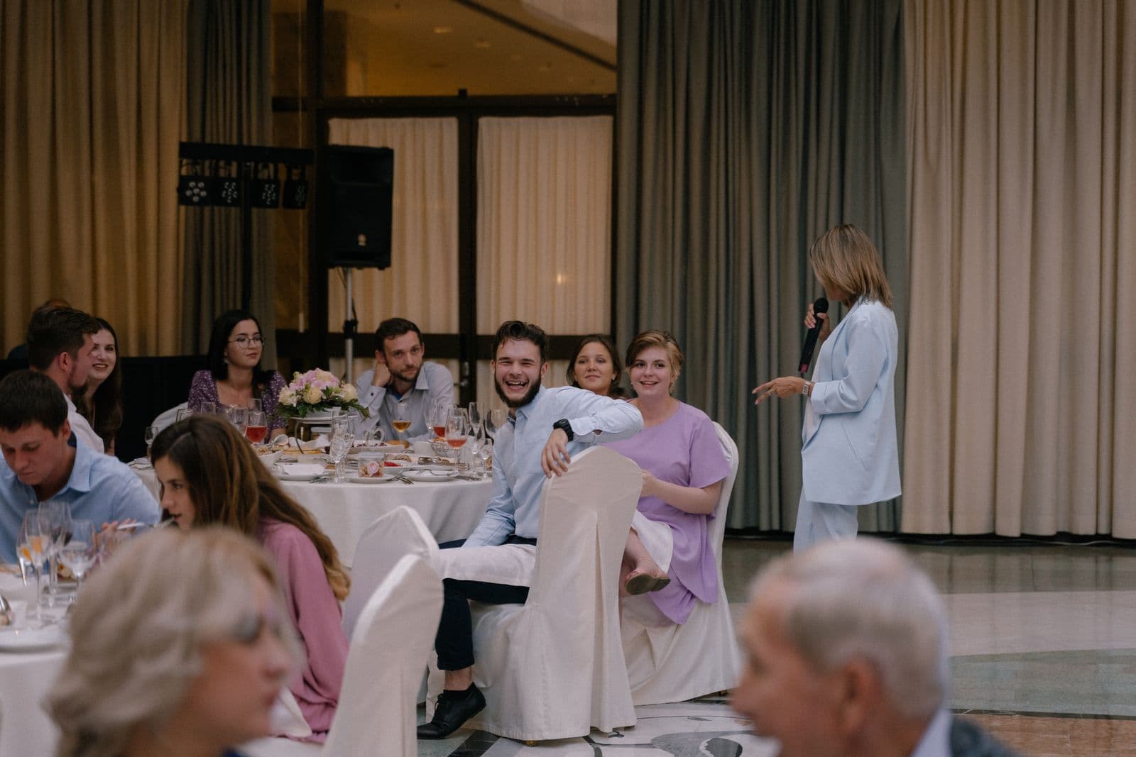 Wedding guests laughing and watching during the reception