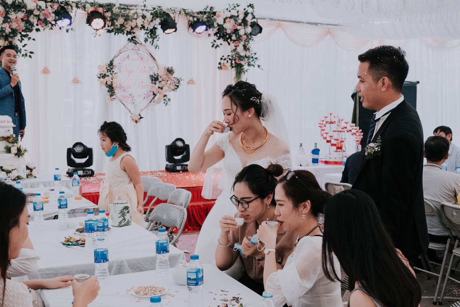 Wedding guests raising a toast at a reception table